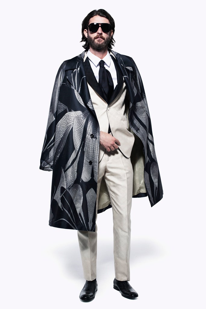 black and white printed coat with beige suit