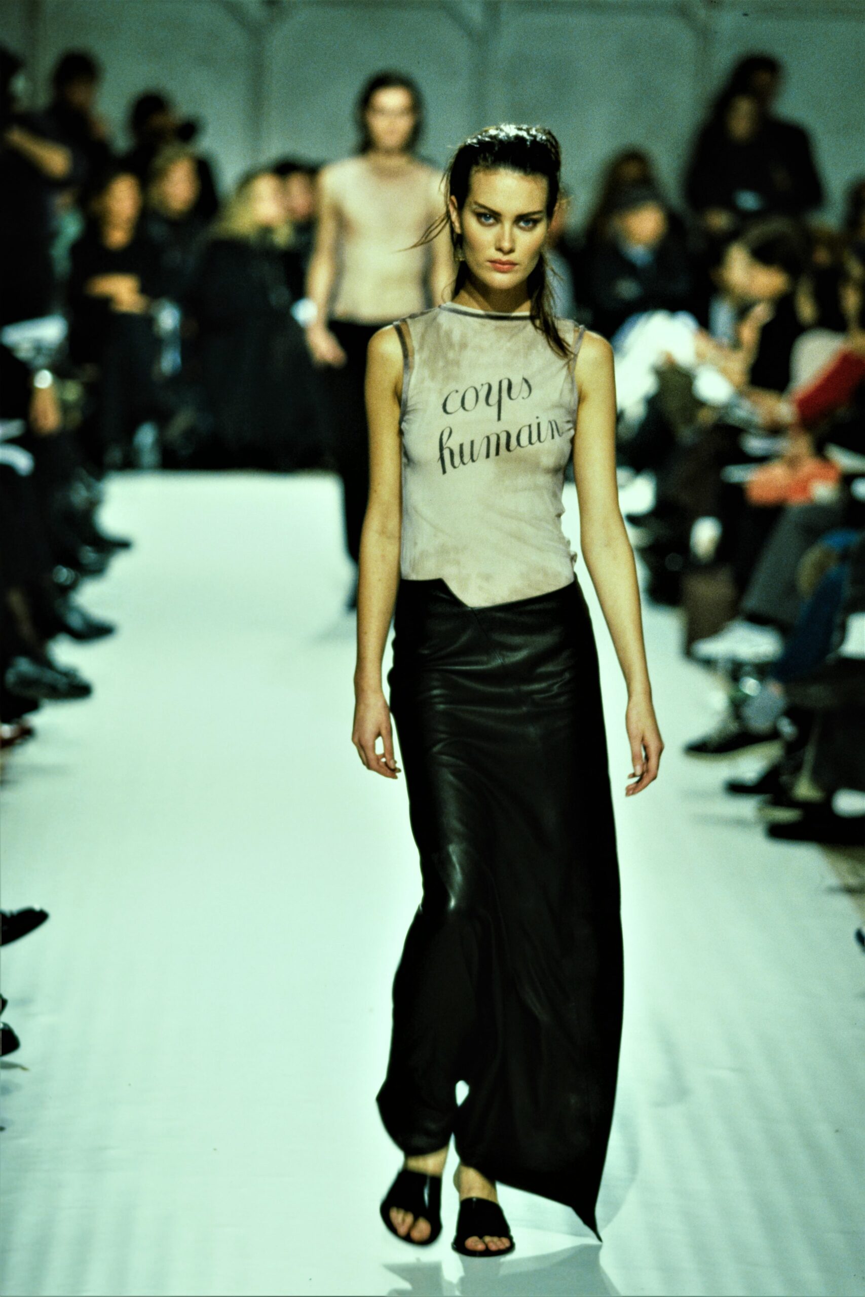 beige silk sleeveless top and black leather skirt