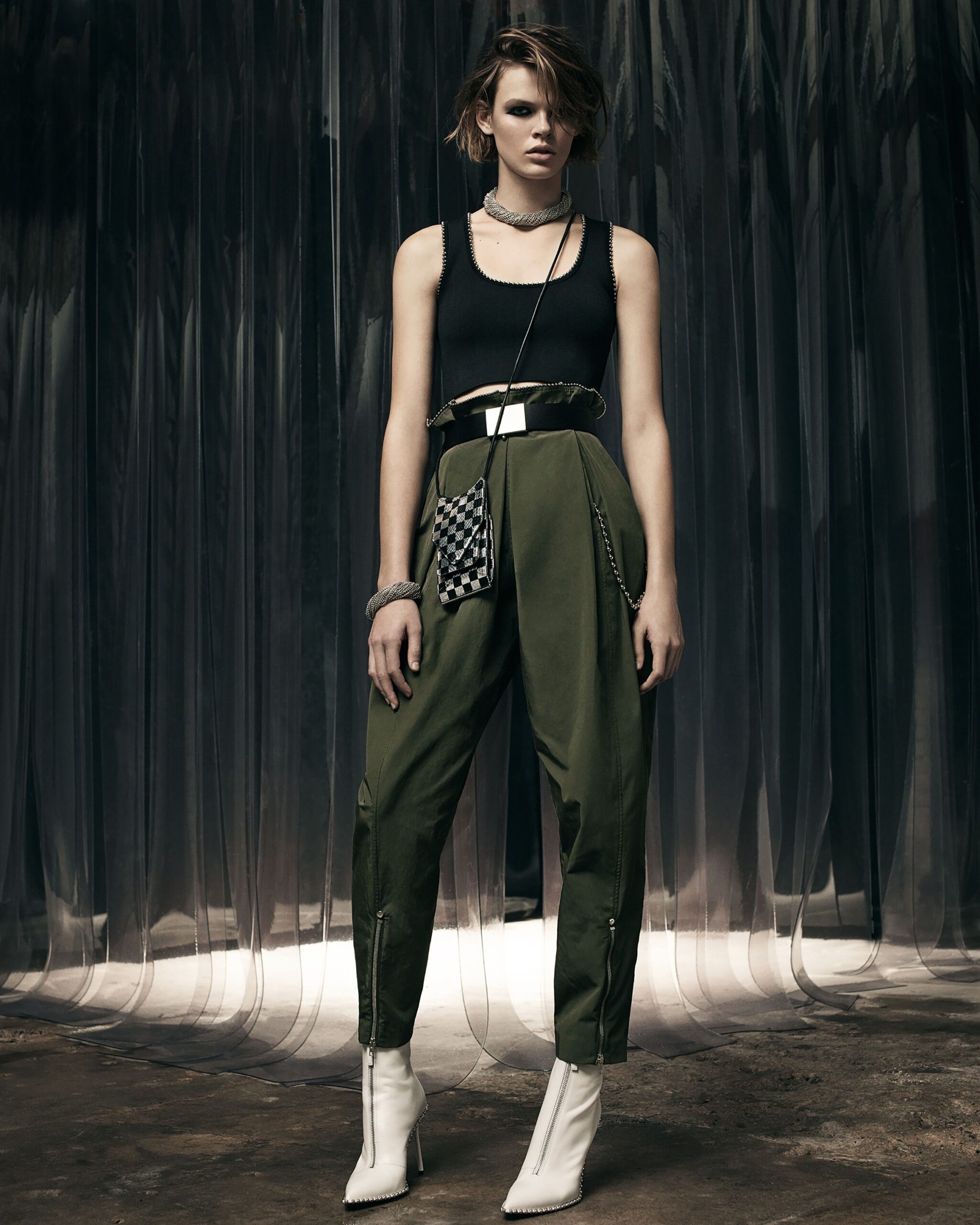 black fitted top with green pants