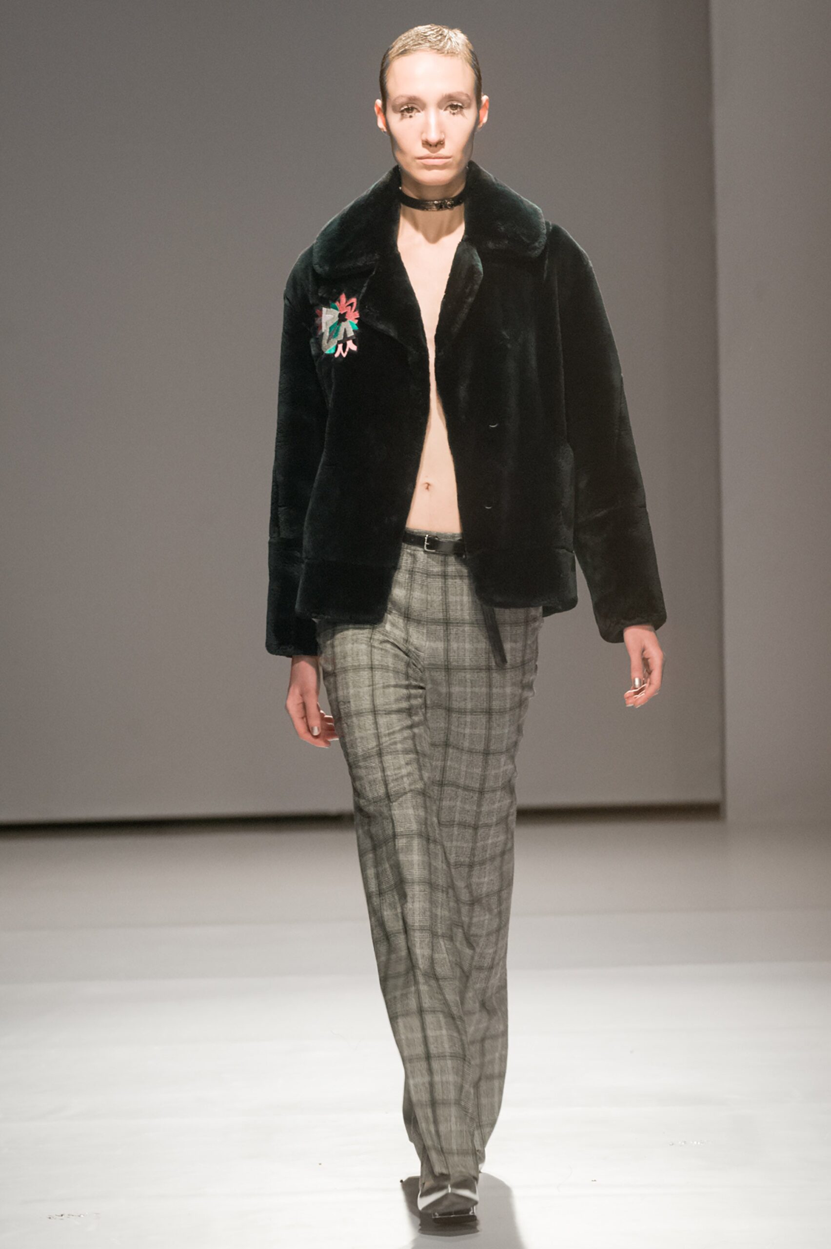 black faux-fur jacket with gray pants