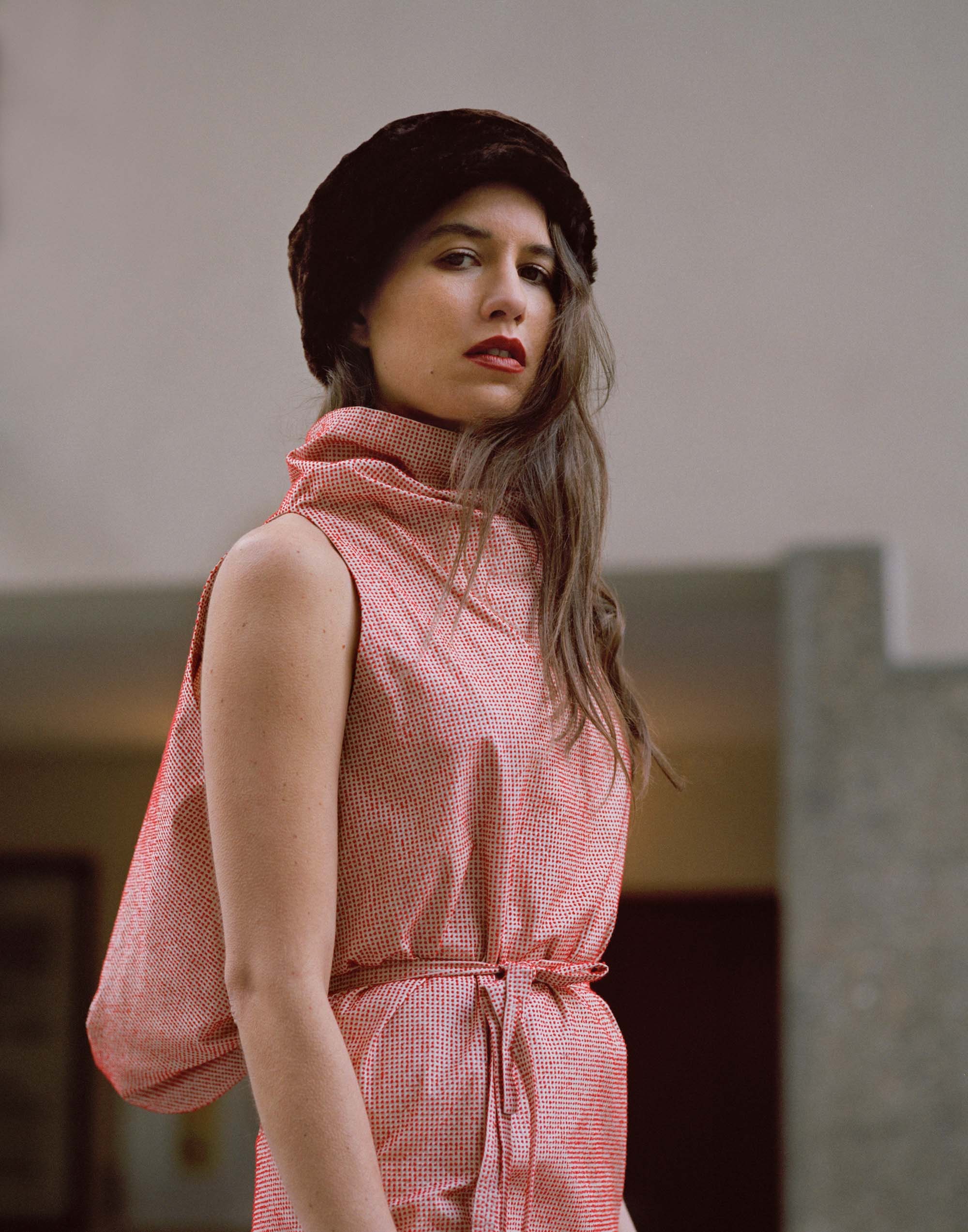 red silk fitted dress with black fur hat