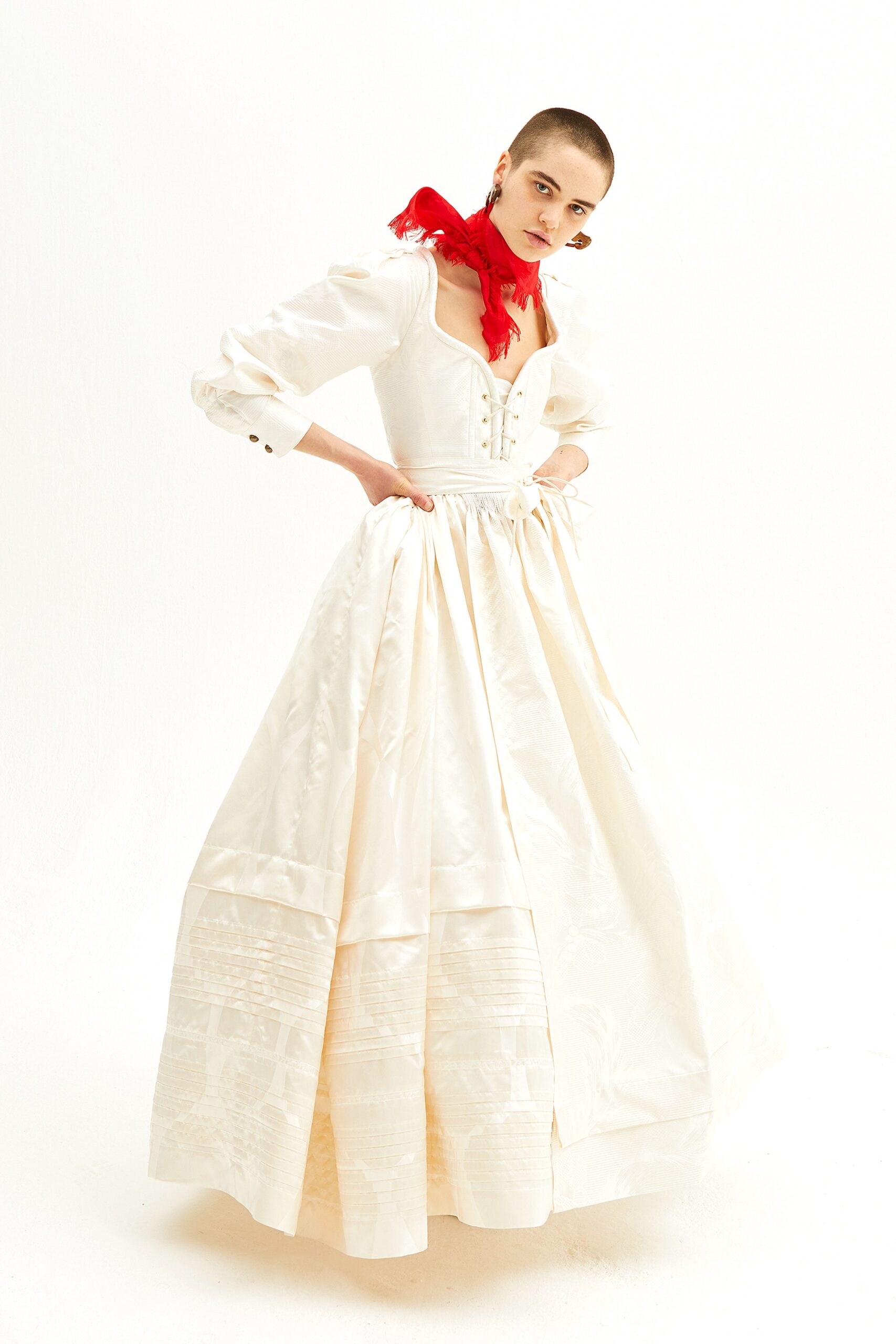 white silk gown with red scarf