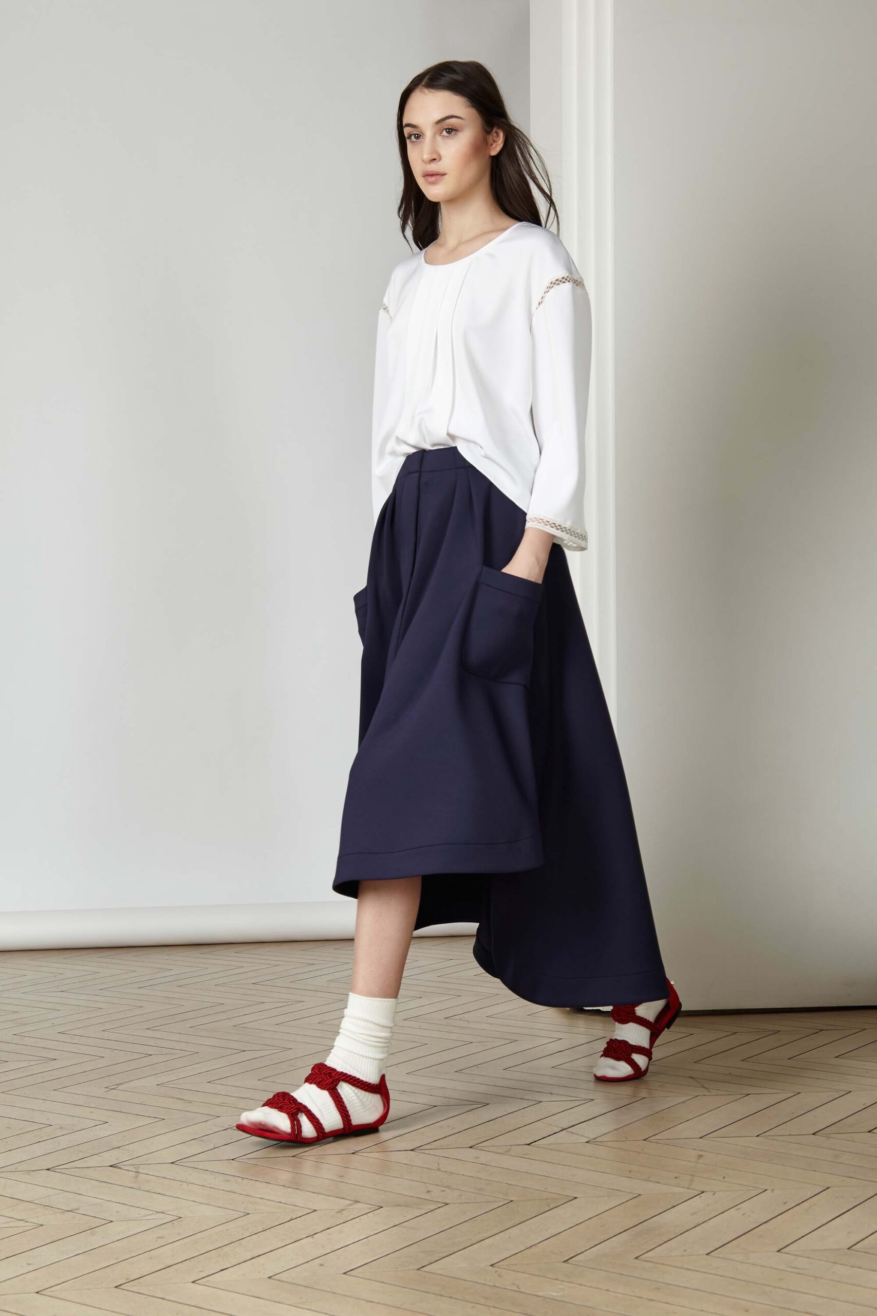 white relaxed top with navy midi skirt