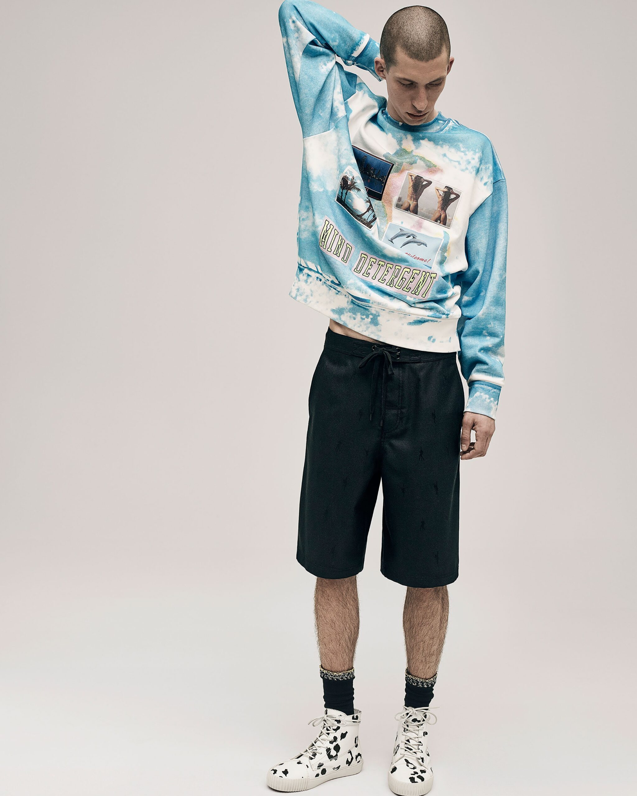 blue relaxed sweater with black shorts