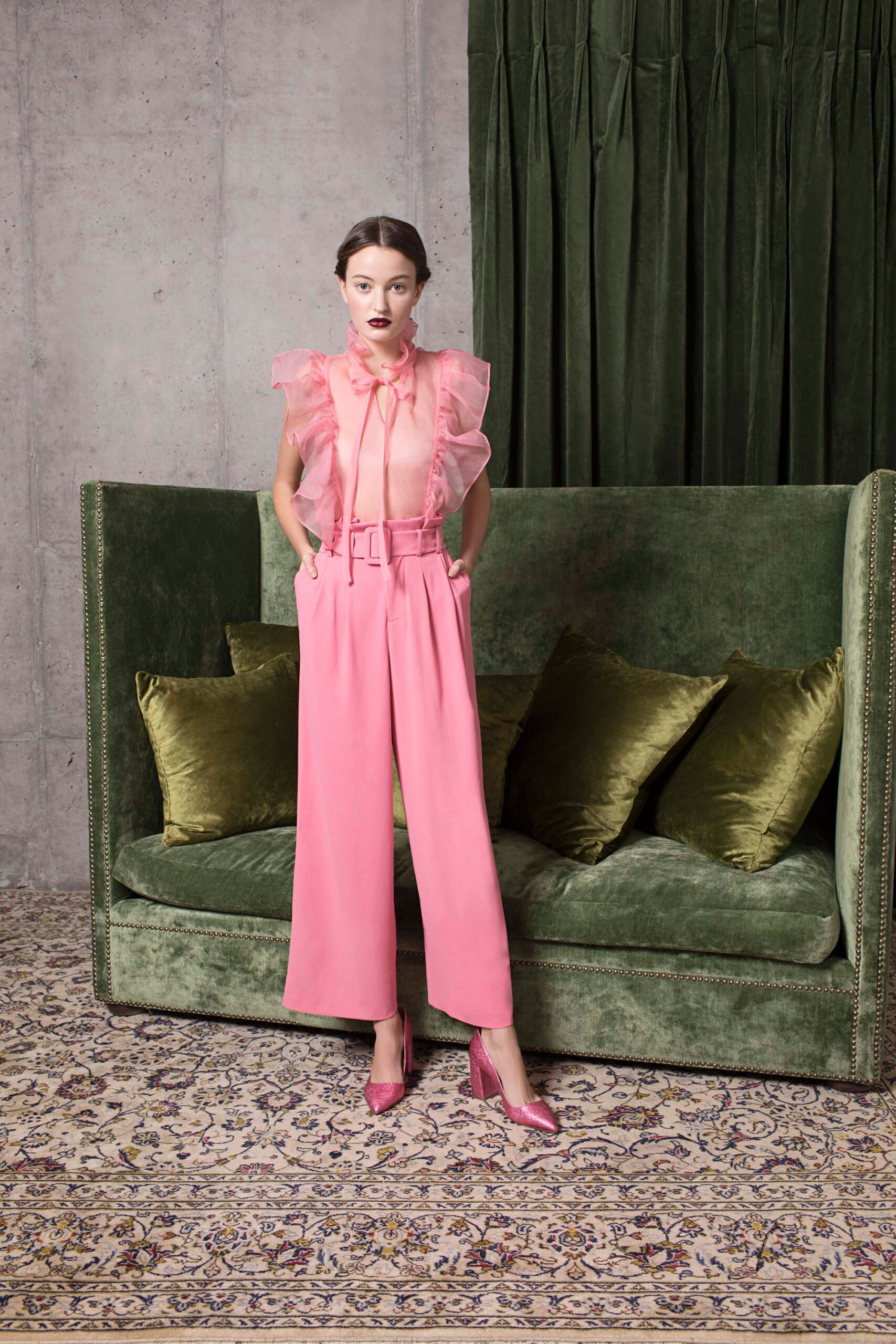 pink silk ruffled blouse and wide-leg pants