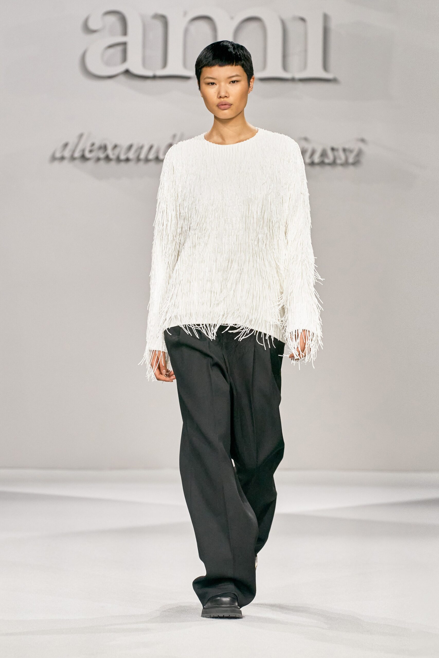 white fringed top and black pants