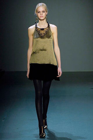 gold sleeveless top with black skirt