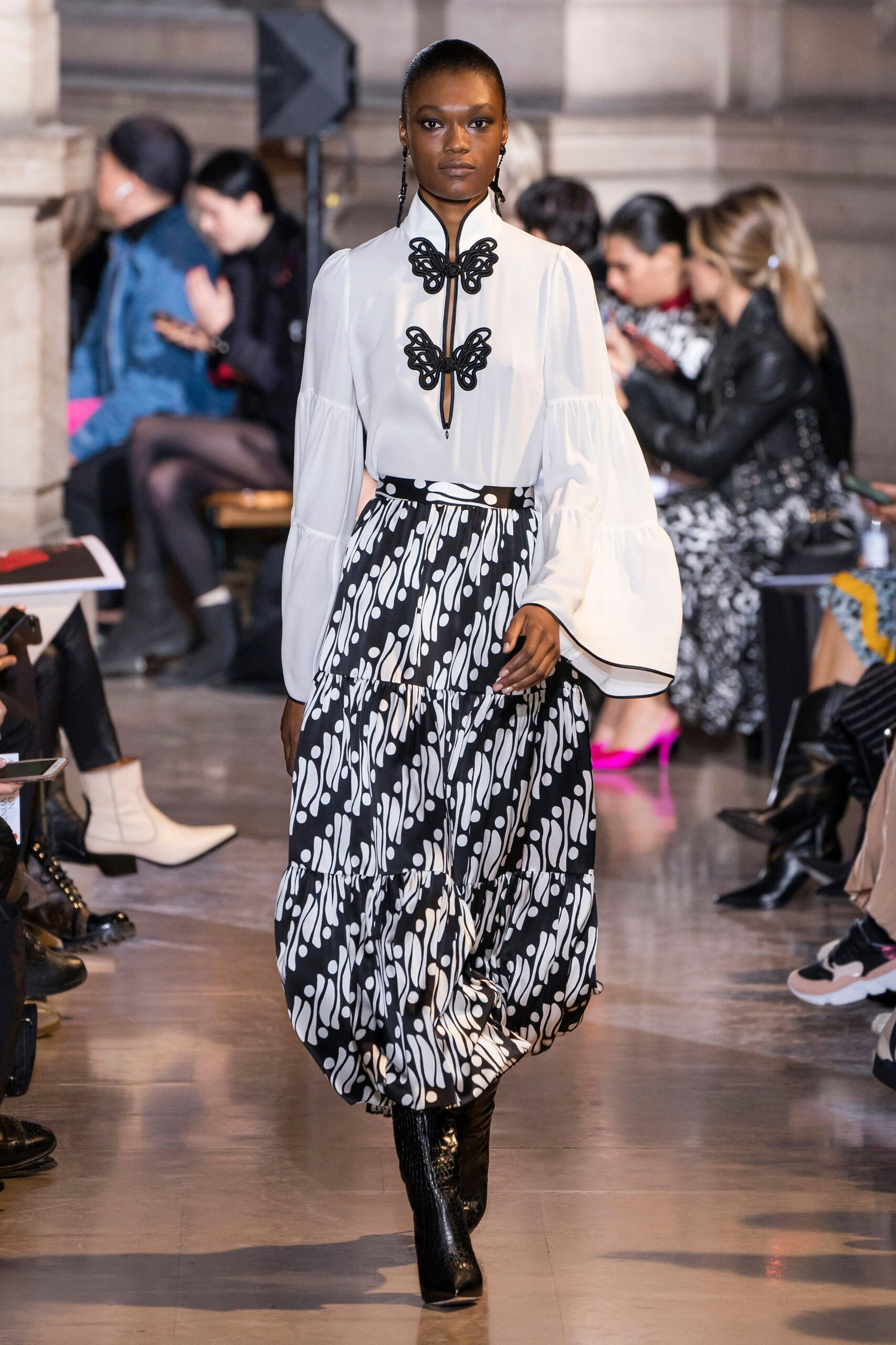 white ruffled blouse black pleated skirt