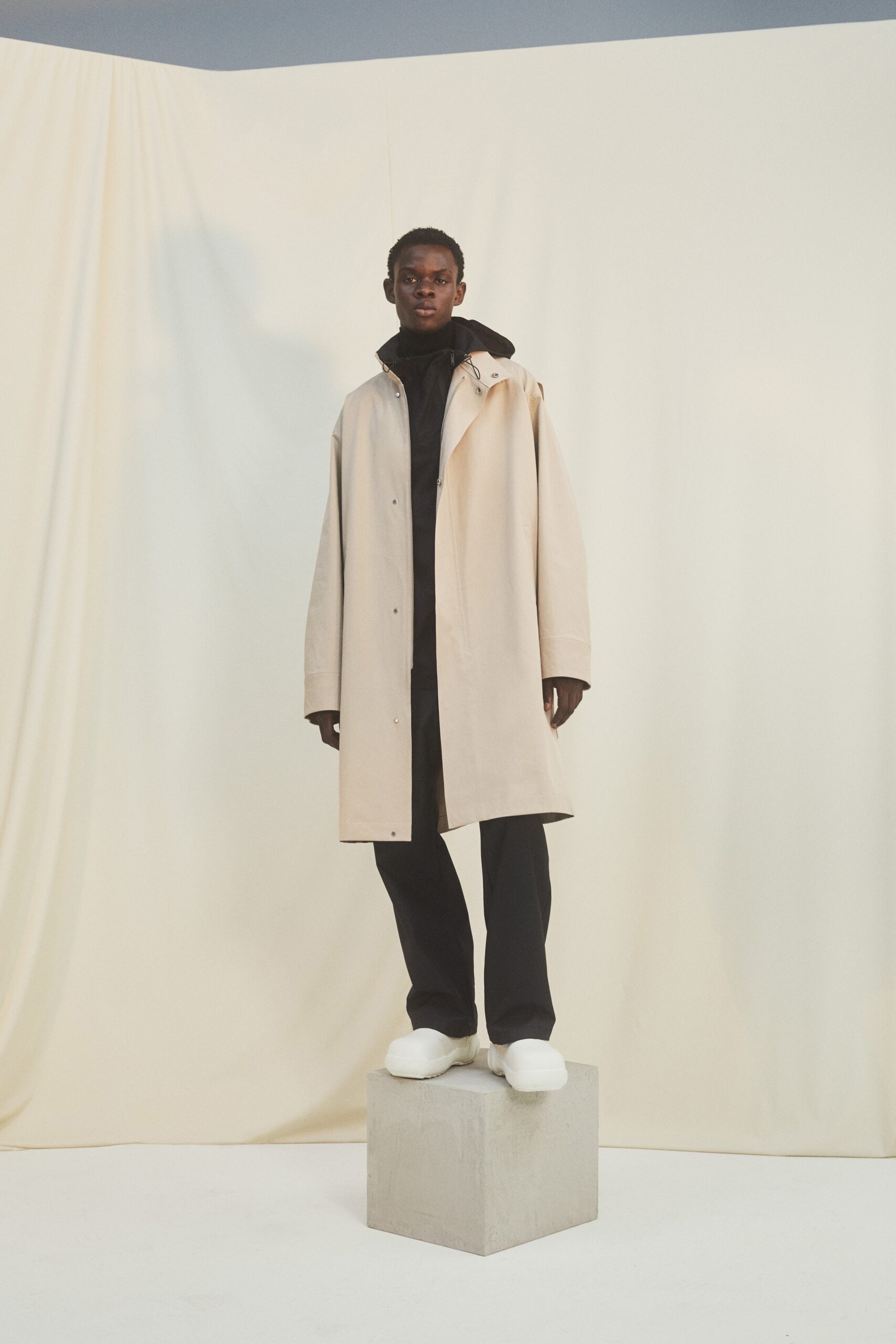 beige oversized coat with black hoodie