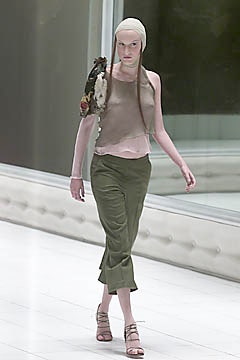 beige silk sleeveless top with green pants