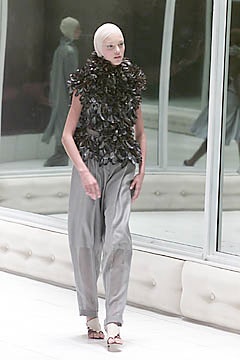 black ruffled top with gray pants