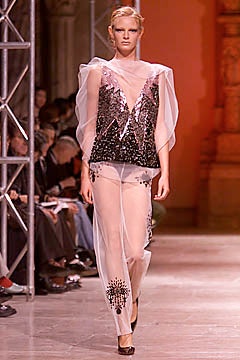 black sequined sheer top with beige pants