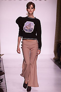 black cropped sweater and beige flared pants