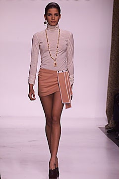 white fitted turtleneck top and peach mini skirt