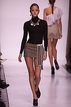 black fitted turtleneck top and beige asymmetric mini skirt