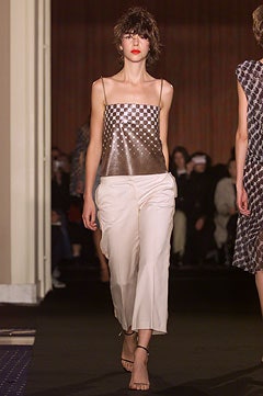 gold checkered sleeveless top with white pants