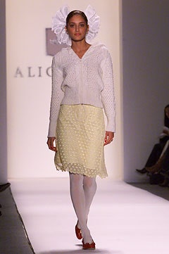 white knitted cardigan and yellow pleated skirt