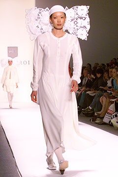 white silk long-sleeve dress with structured hat