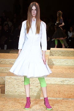 white pleated midi dress with green leggings and pink boots