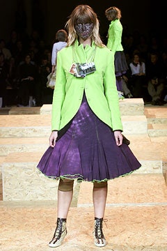 green tailored blazer with purple flared skirt