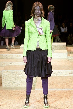 green fitted blazer with black skirt