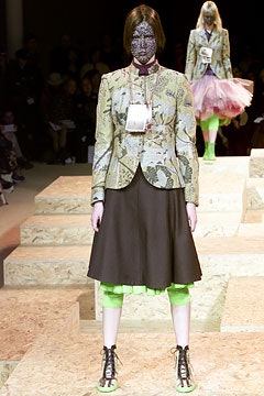 embroidered green blazer with black skirt