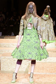 green flared dress with gold jacket