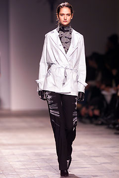white fitted jacket and black slim pants