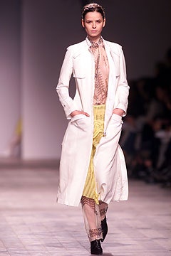 white coat beige blouse yellow skirt