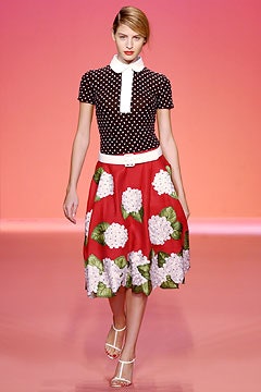 black polka-dot top with red skirt