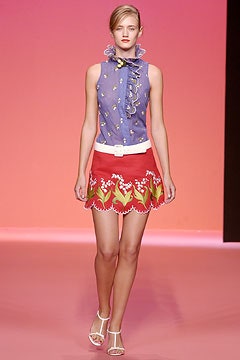 blue ruffled top and red embroidered skirt