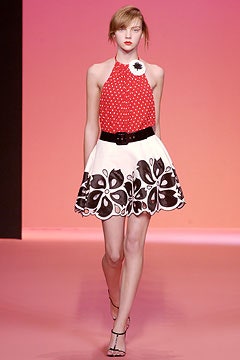 red polka-dot top with white skirt