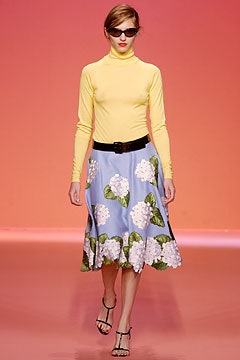 yellow turtleneck top and blue flared skirt