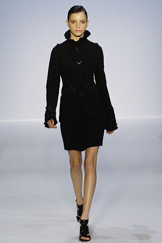 black fitted jacket and mini skirt