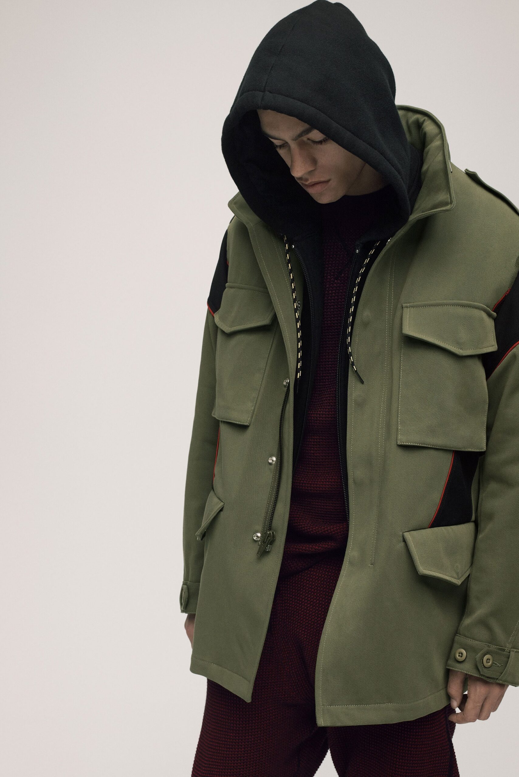 green hooded jacket with red sweater