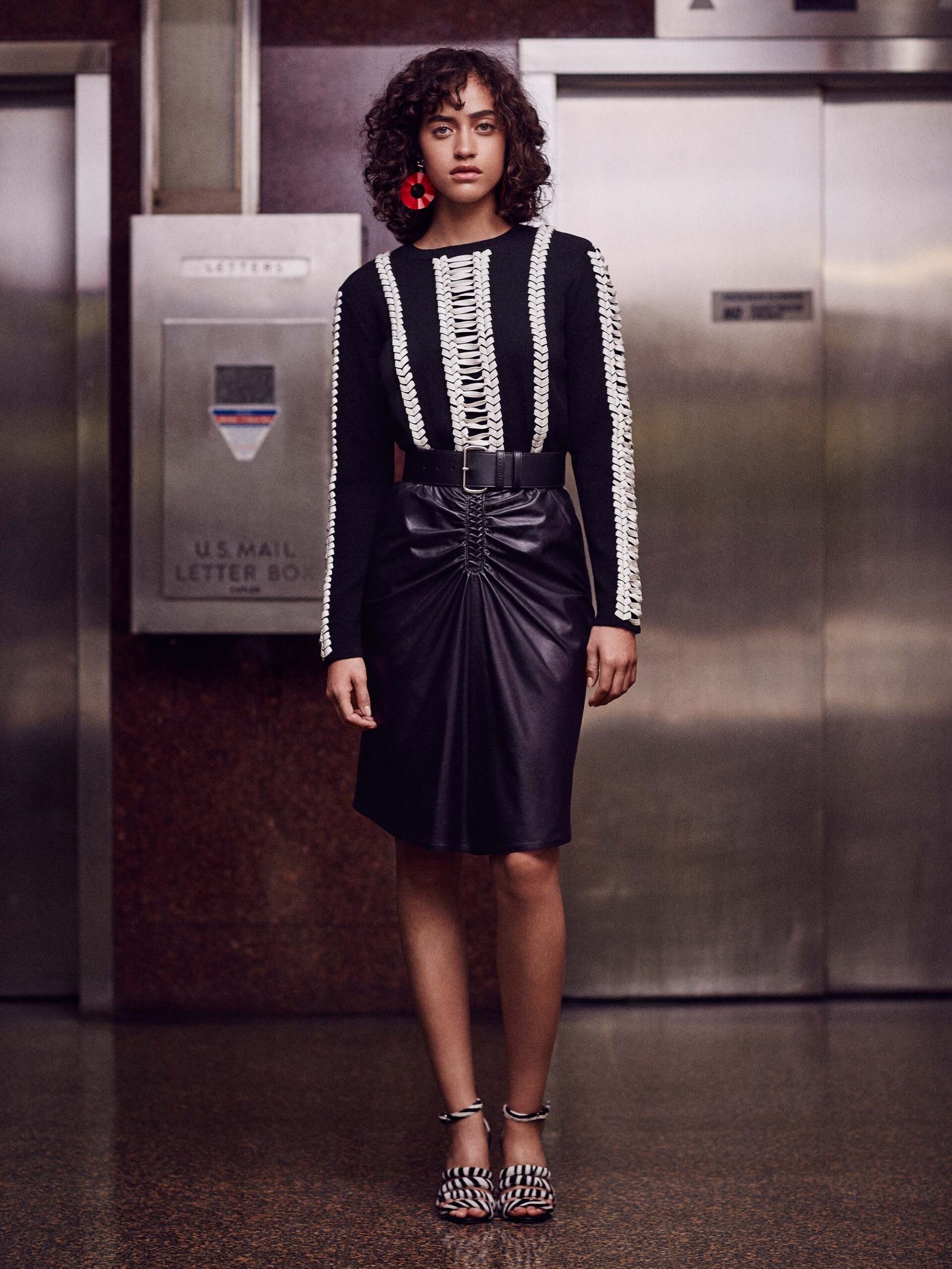black and white fitted top with leather skirt