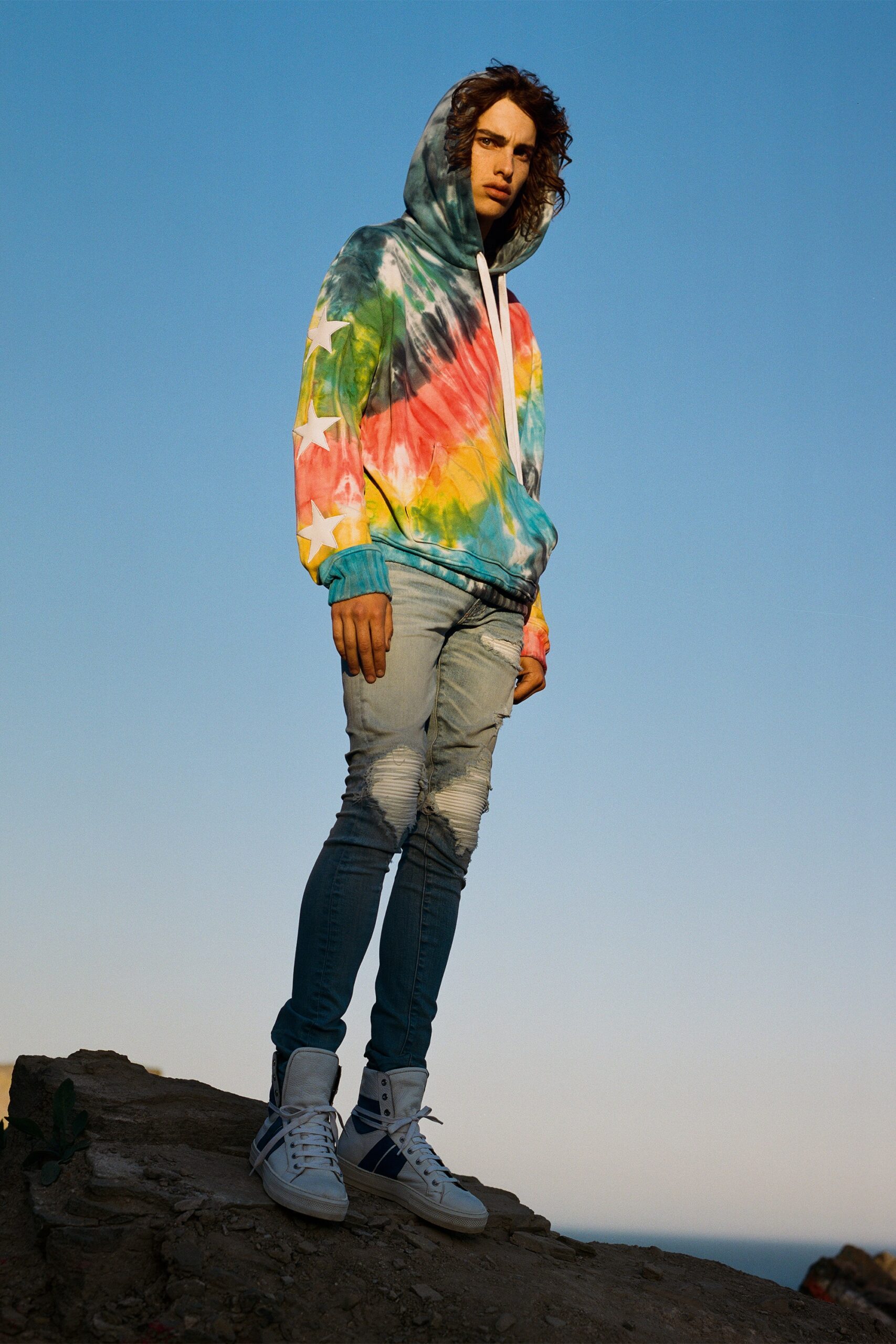 multi-colored tie-dye hoodie and blue jeans