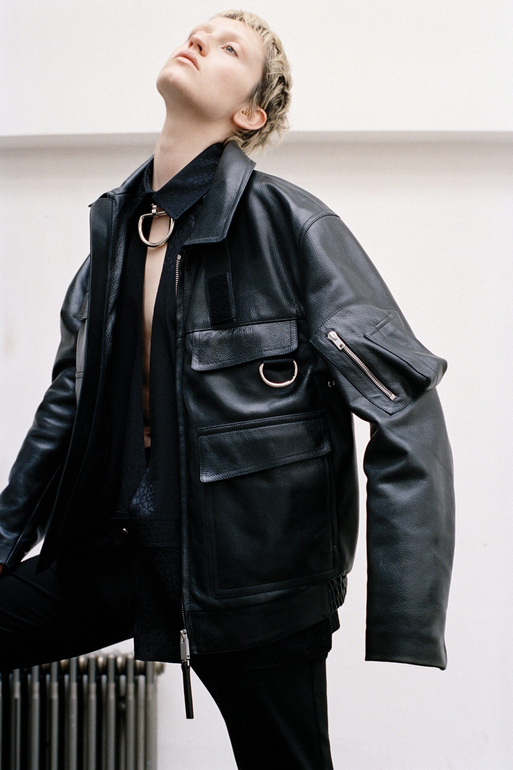 black leather long-sleeve collared relaxed zippered pockets jacket