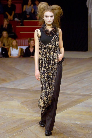black and gold draped dress with slim pants