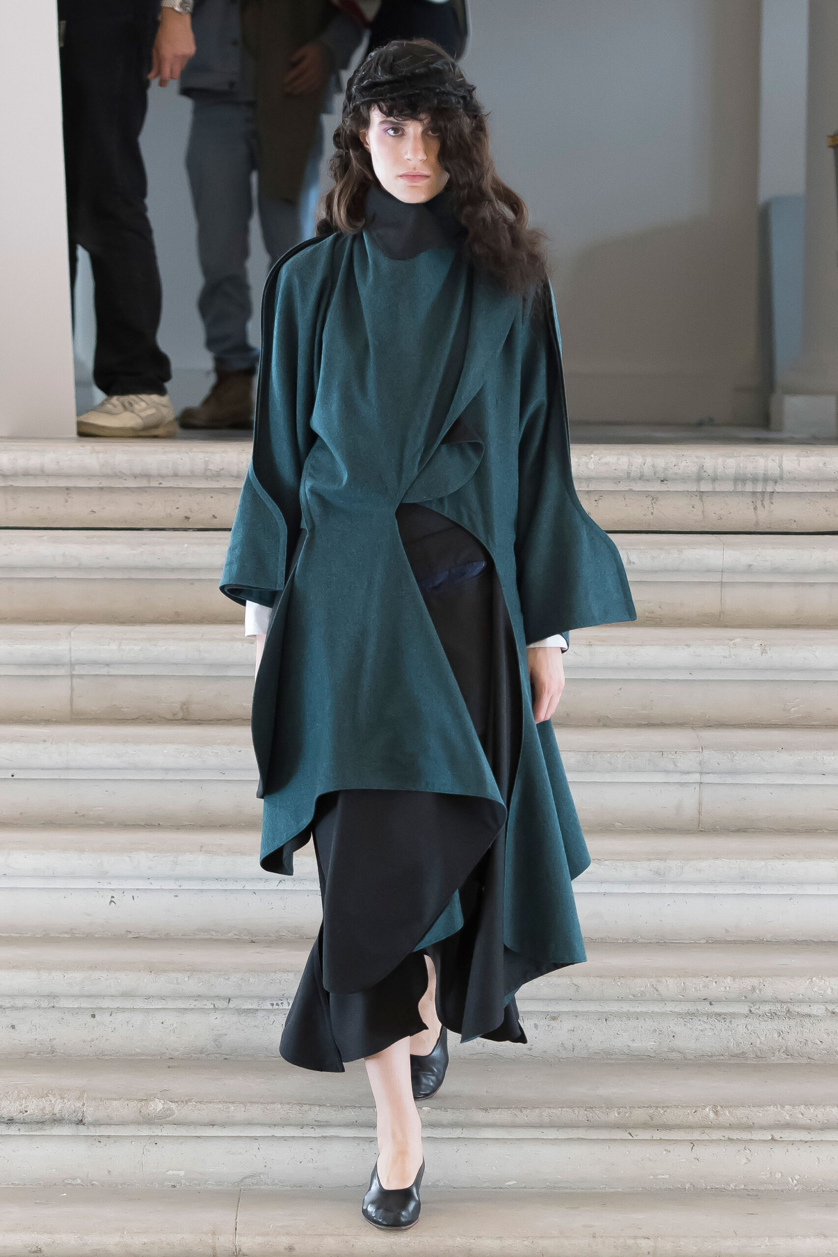 green wool draped coat and black dress