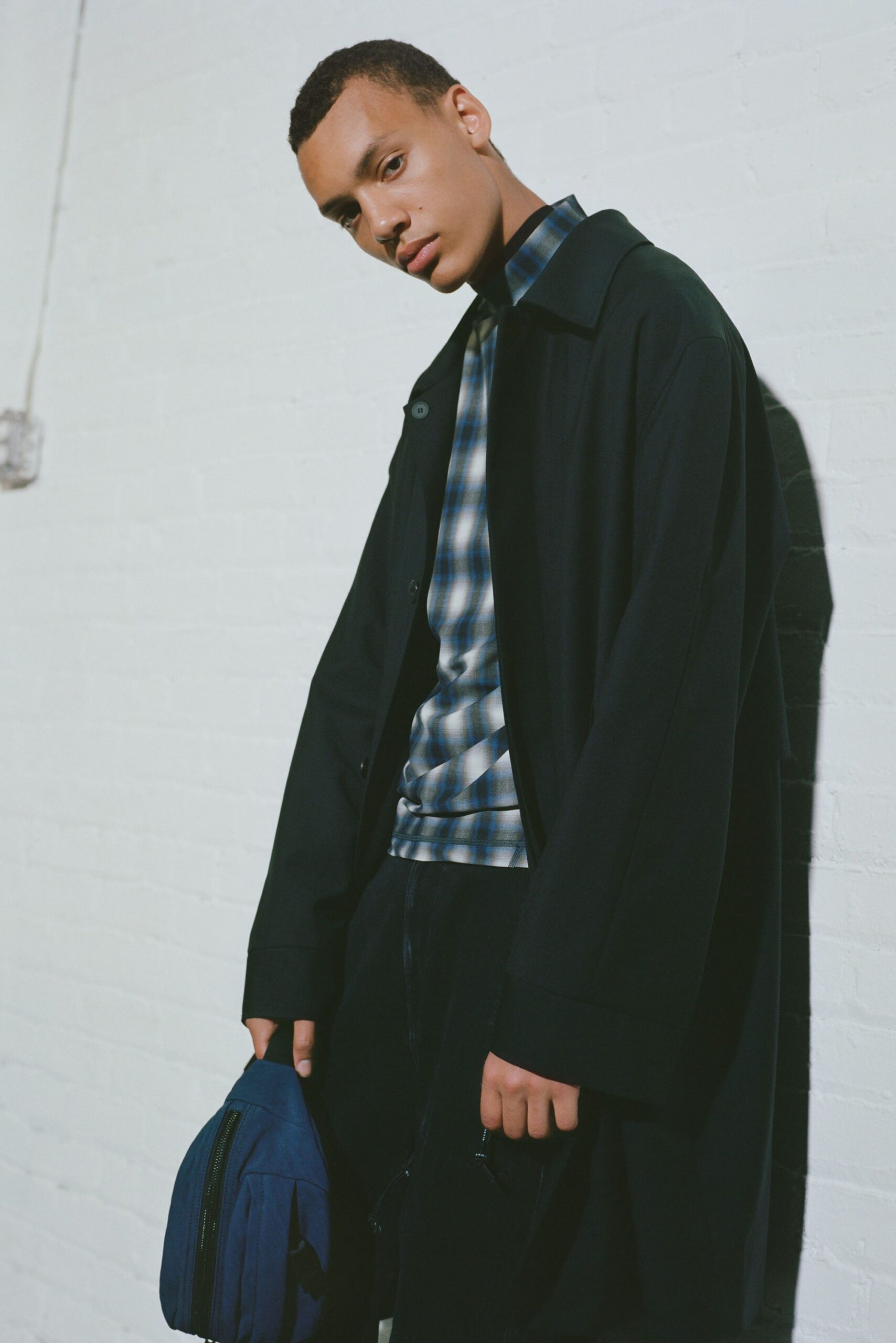 black cotton long-sleeve collared relaxed buttoned coat