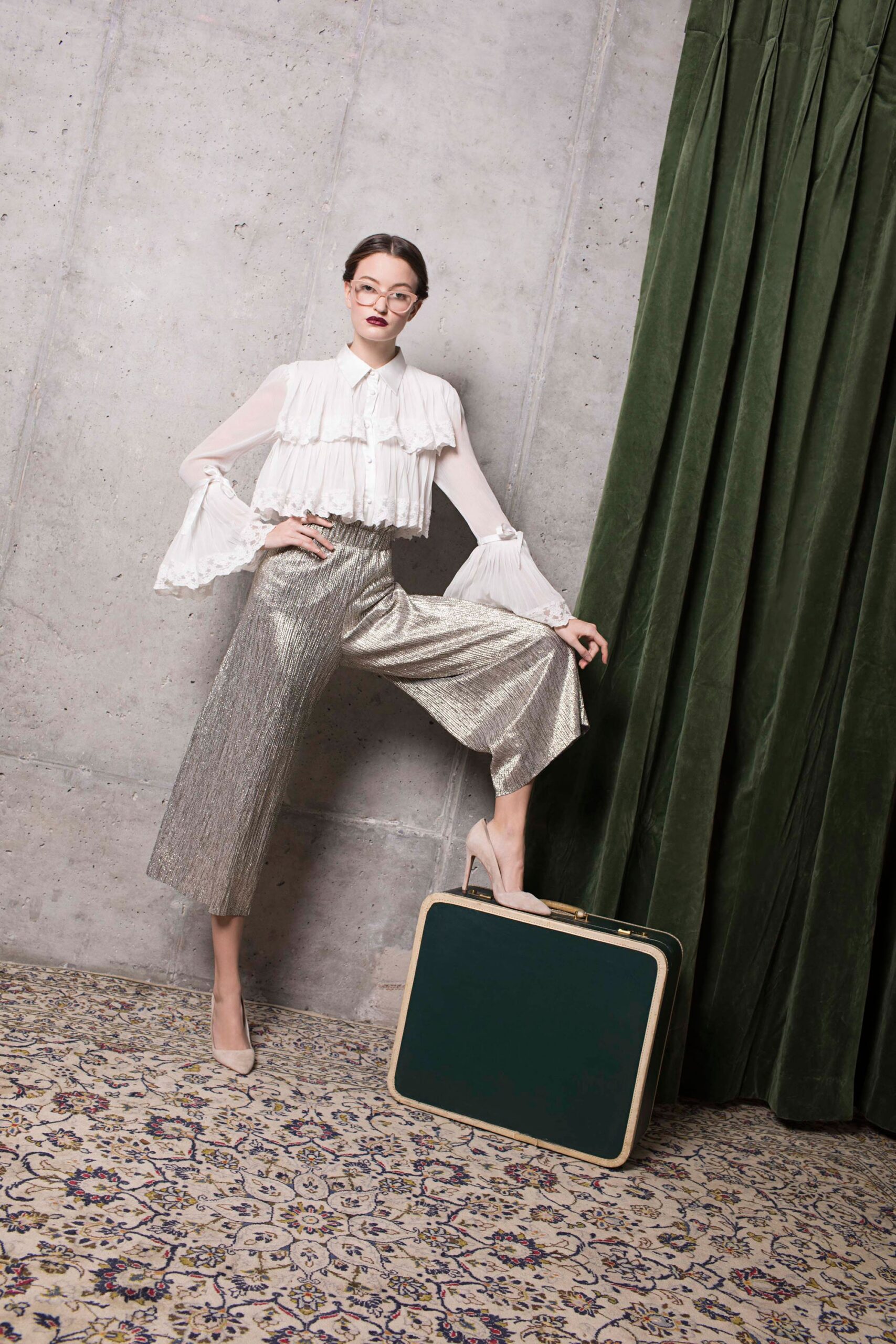 white ruffled blouse and silver wide-leg pants