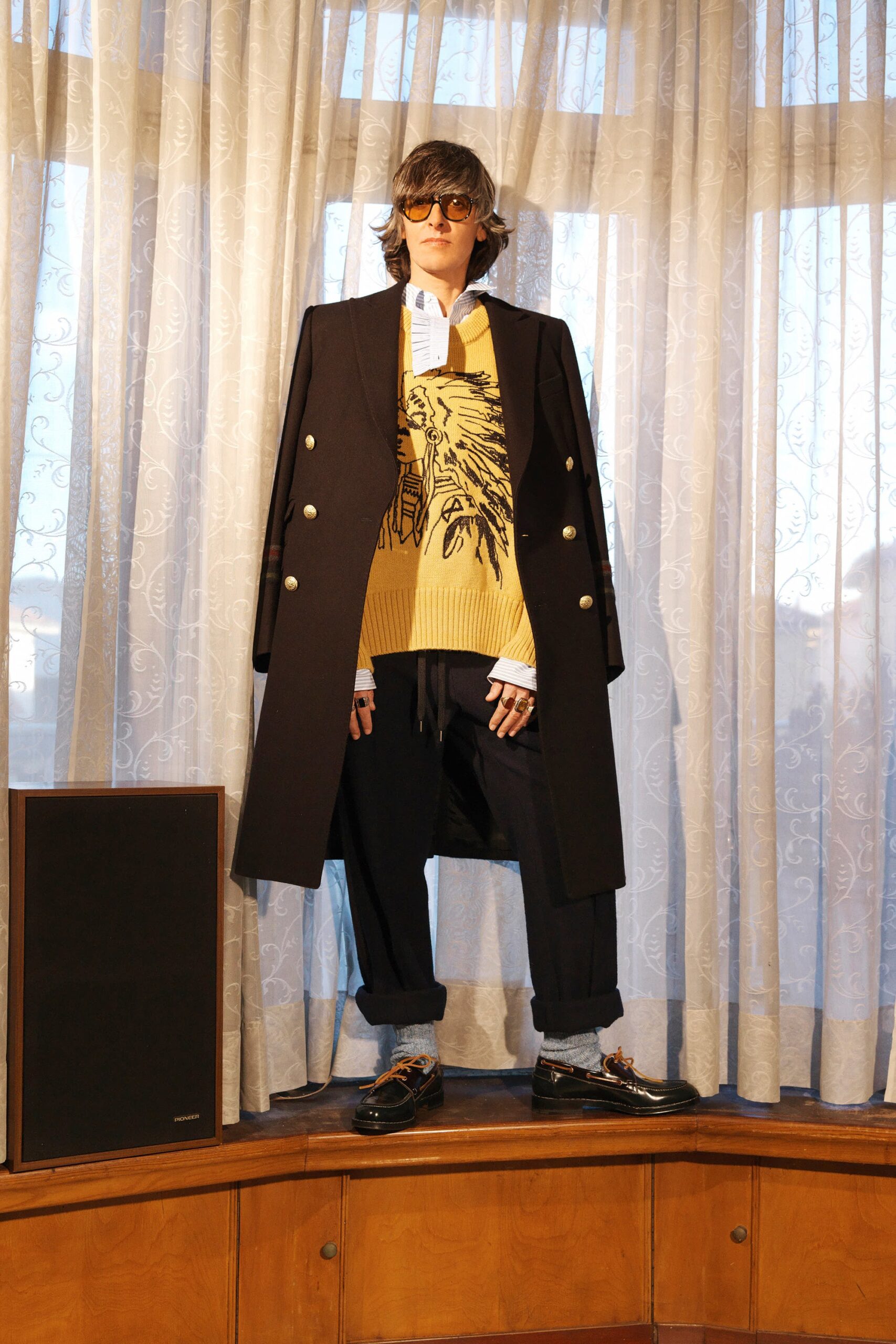 black tailored coat with yellow sweater