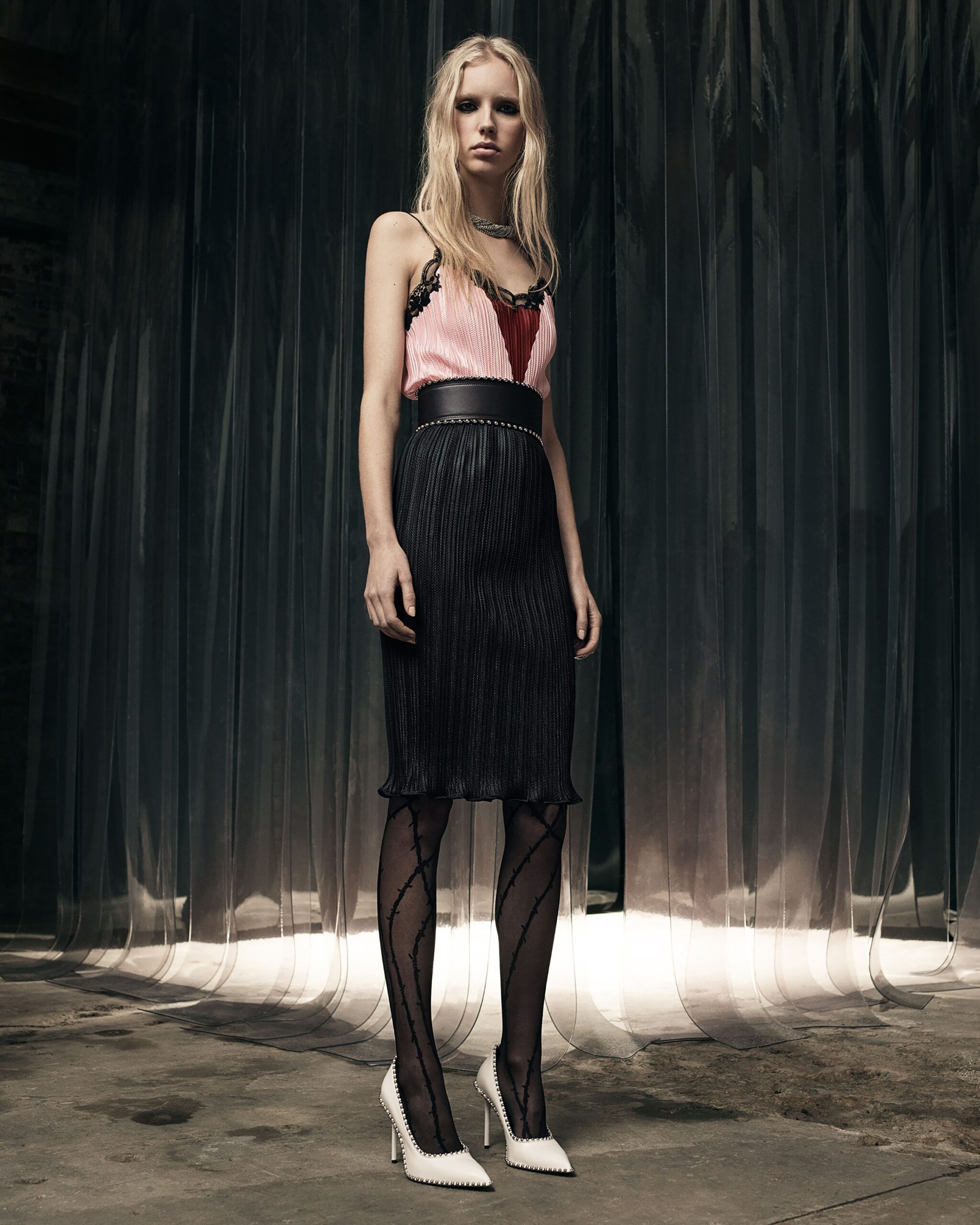 fitted pink silk top with pleated black skirt