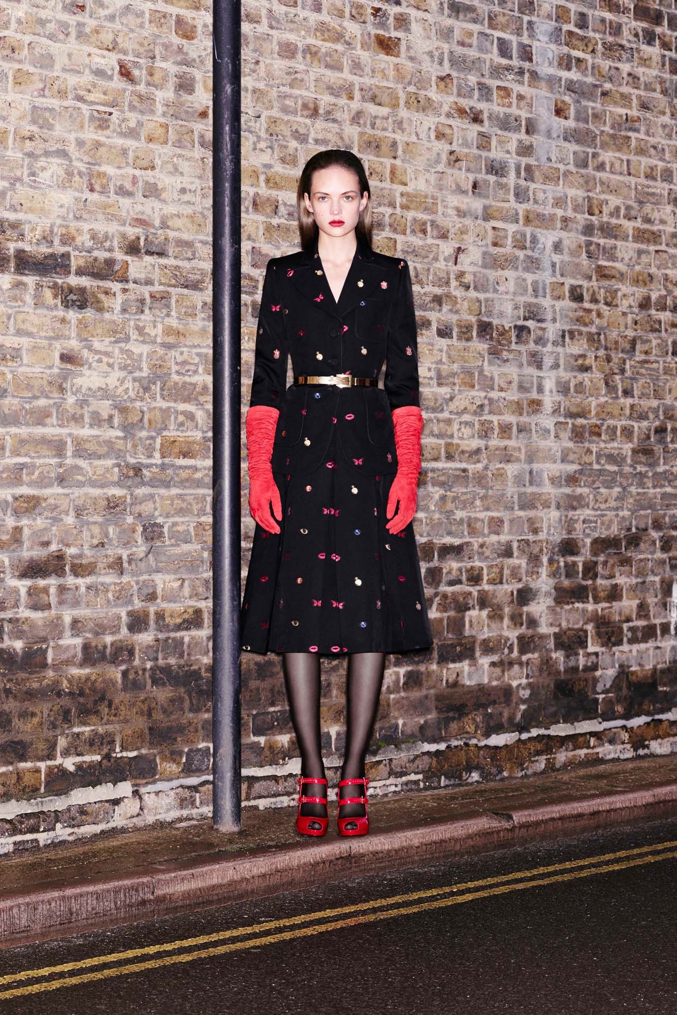 black fitted midi dress with red gloves