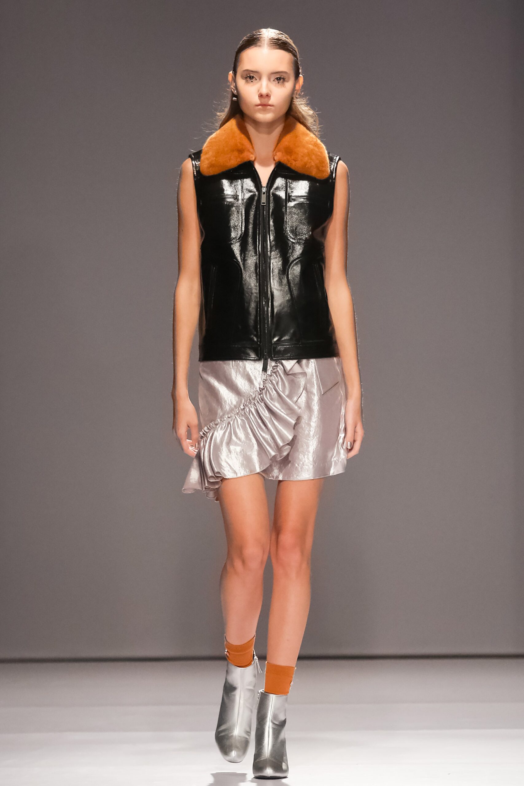 black leather vest and silver skirt