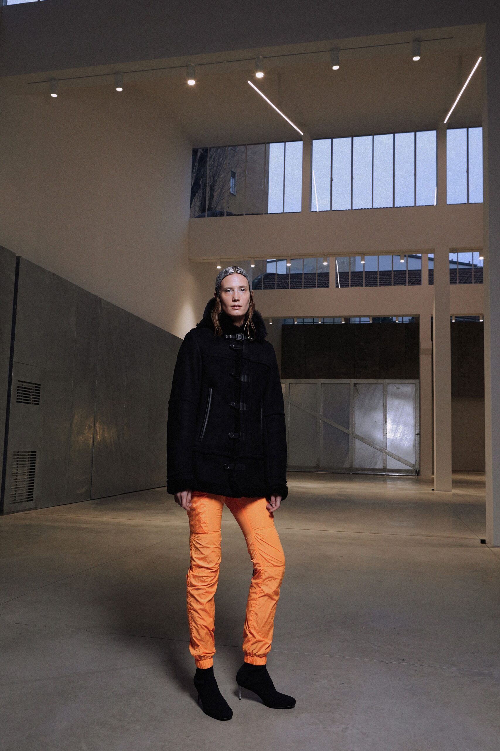 black fitted jacket and orange pants