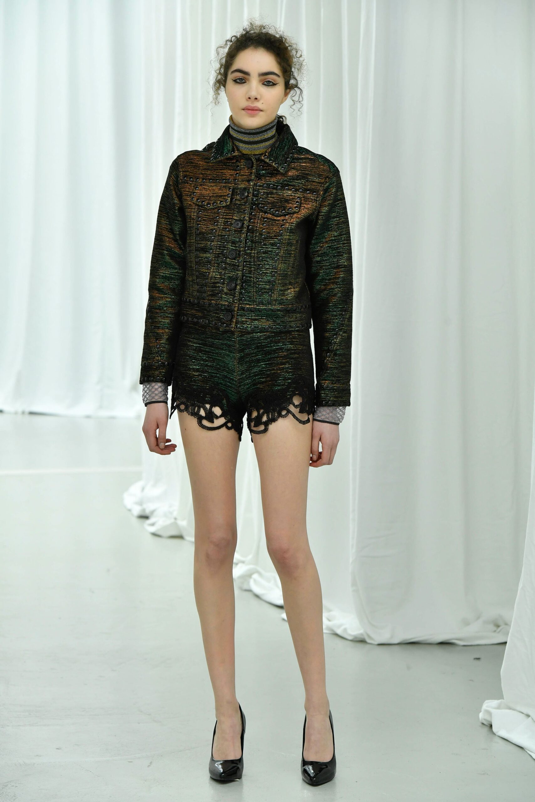 fitted green jacket with black shorts