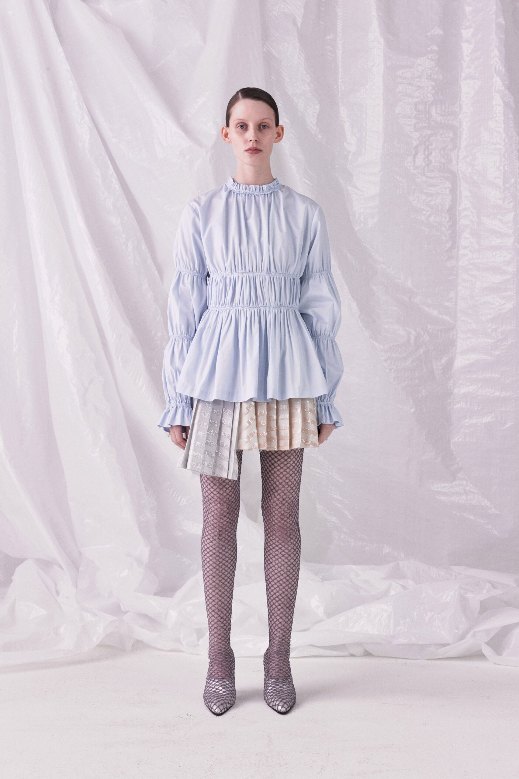 blue fitted top with pleated mini skirt