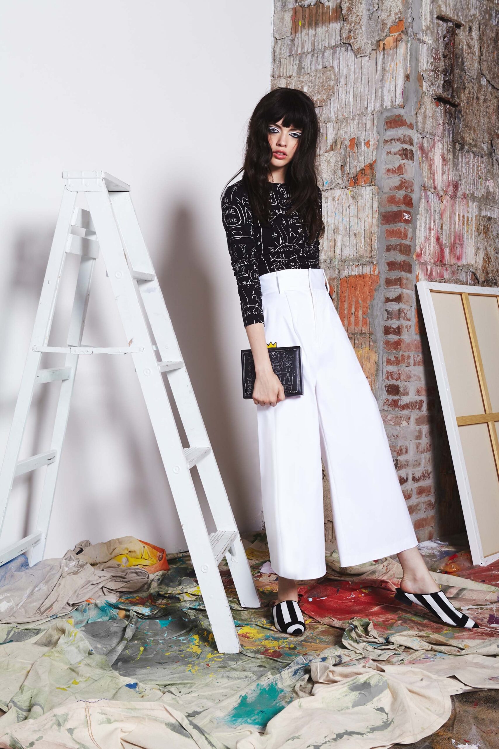black printed fitted top and white wide-leg pants